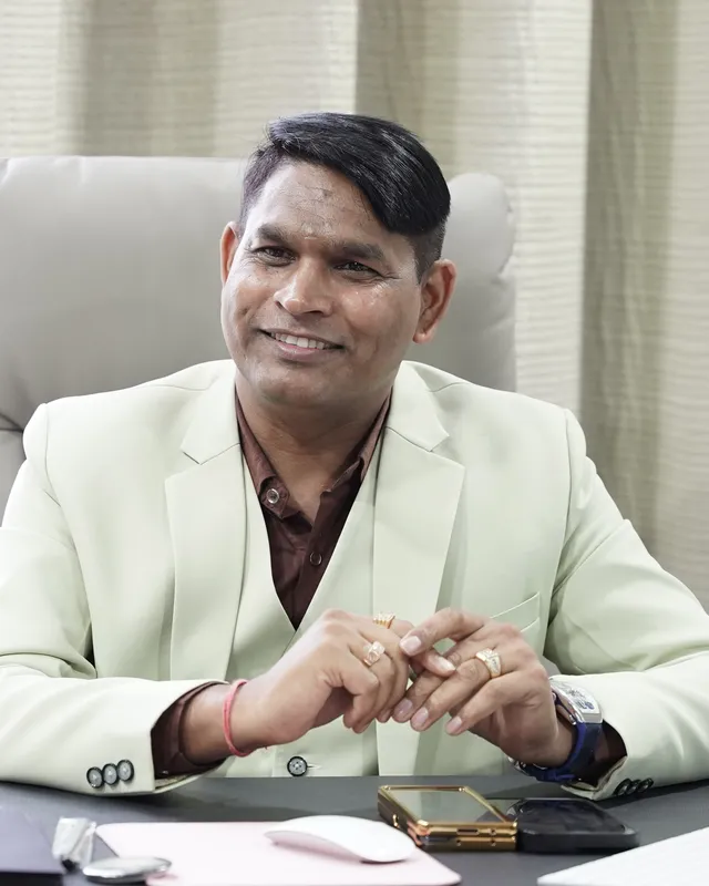 Dr. Rajendra Upadhye smiling at his desk
